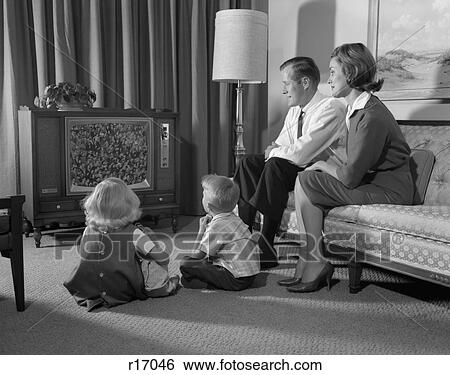 1960S Family Four In Living Room Watching Television Mom Dad On Couch Boy Girl Sit On Floor View Large Photo Image Stock Photograph - 1960S Family Four In Living Room Watching Television Mom Dad On Couch Boy Girl Sit On Floor. Fotosearch