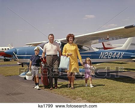 1960S Family Of 4 Walking From Private Plane Across Tarmac Travel Trip Luggage Mother Father Son Daughter View Large Photo Image Stock Photo - 1960S Family Of 4 Walking From Private Plane Across Tarmac Travel Trip Luggage Mother Father Son Daughter. Fotosearch