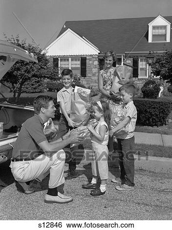 1960S Family Of 5 Unloading Groceries From Car Trunk View Large Photo Image Stock Photograph - 1960S Family Of 5 Unloading Groceries From Car Trunk . Fotosearch