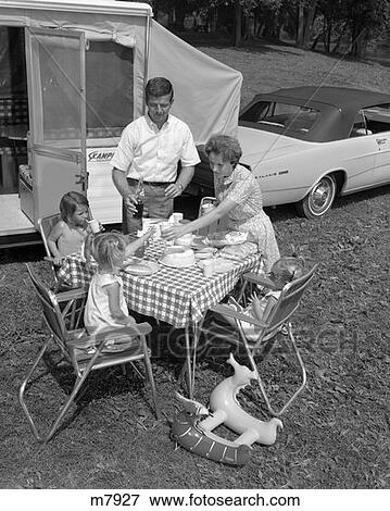1960S Family Of Five Having A Picnic Beside Their Parked Car And Camper Trailer View Large Photo Image Stock Photo - 1960S Family Of Five Having A Picnic Beside Their Parked Car And Camper Trailer. Fotosearch