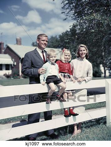 1960S Family Of Four At Fence Of Suburban Home Outdoor Man Woman Boy Girl Nostalgia View Large Photo Image Stock Photo - 1960S Family Of Four At Fence Of Suburban Home Outdoor Man Woman Boy Girl Nostalgia. Fotosearch