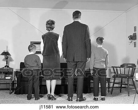 1960S Family Of Four Facing Away Standing In Living Room Mother Father Two Boys View Large Photo Image Stock Image - 1960S Family Of Four Facing Away Standing In Living Room Mother Father Two Boys. Fotosearch