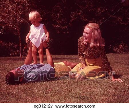 1960S Family On Grass Father Holding Up Toddler View Large Photo Image Stock Photo - 1960S Family On Grass Father Holding Up Toddler. Fotosearch