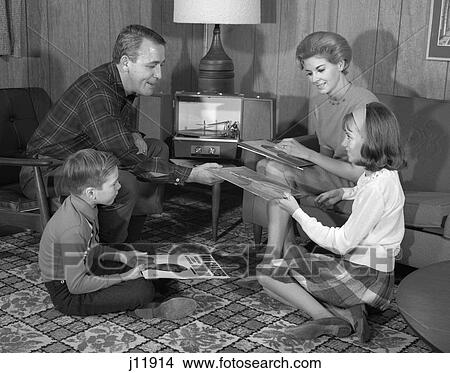 1960S Family Playing Records On A Portable Record Player In Family Room View Large Photo Image Picture - 1960S Family Playing Records On A Portable Record Player In Family Room . Fotosearch