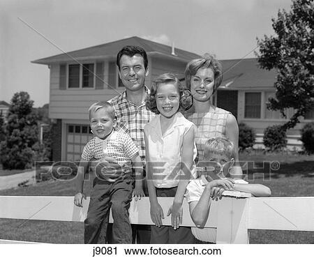 1960S Family Portrait In Front Of House On Fence View Large Photo Image Stock Image - 1960S Family Portrait In Front Of House On Fence . Fotosearch