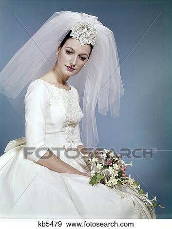 1960S Formal Portrait Of Bride Sitting Holding Flower Bouquet View Large Photo Image Stock Photo - 1960S Formal Portrait Of Bride Sitting Holding Flower Bouquet . Fotosearch