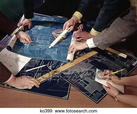 1960S Group 4 Pair Male Hands Over Table Covered With Papers Blueprints Plans Meeting Architects Builders View Large Photo Image Stock Photo - 1960S Group 4 Pair Male Hands Over Table Covered With Papers Blueprints Plans Meeting Architects Builders. Fotosearch