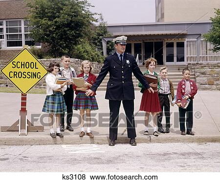 1960S Group School Children Waiting To Cross Street Police Officer Holding Back Hands At Curb Crossing View Large Photo Image Stock Photo - 1960S Group School Children Waiting To Cross Street Police Officer Holding Back Hands At Curb Crossing. Fotosearch