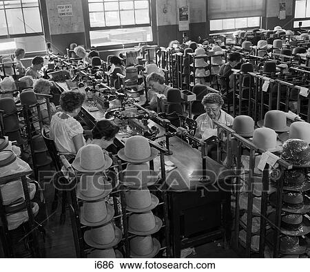 Stock Photograph - 1960S Hat-Making Factory With Rows Of Women At Long Table Hand-Trimming Stetson Hats . Fotosearch