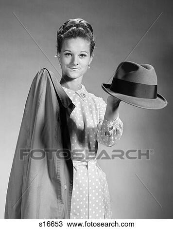 1960S Housewife In Polka-Dotted Dress Holding Out Coat & Hat For Husband View Large Photo Image Stock Image - 1960S Housewife In Polka-Dotted Dress Holding Out Coat & Hat For Husband . Fotosearch