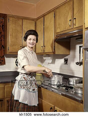 1960S Housewife Woman Kitchen Smile Cook Stove Appliance Apron Cabinets View Large Photo Image Stock Photography - 1960S Housewife Woman Kitchen Smile Cook Stove Appliance Apron Cabinets . Fotosearch