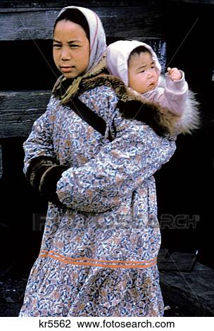 Stock Image - 1960S Inuit Woman Mother Baby Eskimo In Nome Alaksa Native American Indian Girl King Island Arctic Ocean Fur Parka. Fotosearch