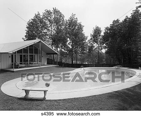 1960S Kidney-Shaped Pool With Beach Balls Floating In It Behind Ranch-Style House View Large Photo Image Stock Photography - 1960S Kidney-Shaped Pool With Beach Balls Floating In It Behind Ranch-Style House . Fotosearch