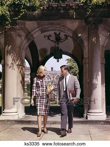 1960S Man And Woman Students With Books At Arch Leading To Campus Quadrangle Couple Two View Large Photo Image Stock Photography - 1960S Man And Woman Students With Books At Arch Leading To Campus Quadrangle Couple Two . Fotosearch