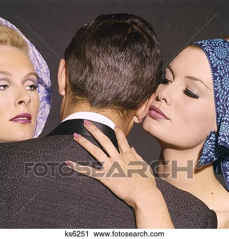1960S Man Back To Camera 2 Glamorous Women Whispering Into Kissing His Ear Hand At His Neck Cheat Gigolo Triangle View Large Photo Image Stock Image - 1960S Man Back To Camera 2 Glamorous Women Whispering Into Kissing His Ear Hand At His Neck Cheat Gigolo Triangle . Fotosearch