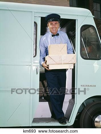 1960S Man Driver Delivery Truck Van Step Out Vehicle Door Holding Packages Boxes Uniform Hat Service Deliver Work View Large Photo Image Stock Image - 1960S Man Driver Delivery Truck Van Step Out Vehicle Door Holding Packages Boxes Uniform Hat Service Deliver Work. Fotosearch