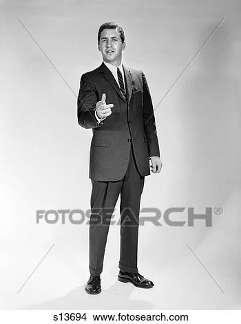1960S Man Full Length Portrait Pointing Gesture Wearing Suit Businessman Spokesperson View Large Photo Image Picture - 1960S Man Full Length Portrait Pointing Gesture Wearing Suit Businessman Spokesperson . Fotosearch