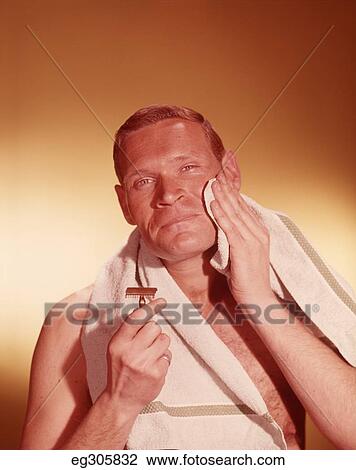 1960S Man Holding Razor Towel Around Neck Wiping Clean Shaven Face View Large Photo Image Stock Image - 1960S Man Holding Razor Towel Around Neck Wiping Clean Shaven Face. Fotosearch