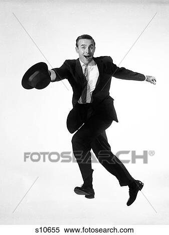 1960S Man In Business Suit Jumping Into Air While Running Hat In Hand Goofy Funny Expression On His Face Hurry Salesman Wacky View Large Photo Image Stock Photography - 1960S Man In Business Suit Jumping Into Air While Running Hat In Hand Goofy Funny Expression On His Face Hurry Salesman Wacky . Fotosearch