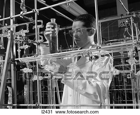 1960S Man In Lab Coat & Goggles Surrounded By Glass Tubing Conducting Scientific Research View Large Photo Image Stock Image - 1960S Man In Lab Coat & Goggles Surrounded By Glass Tubing Conducting Scientific Research . Fotosearch