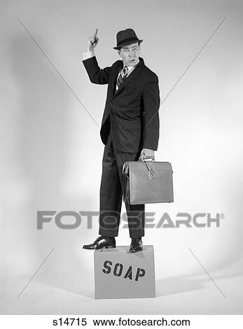 1960S Man Standing On Soap Box Holding Briefcase Suit Tie Hat Gesturing With One Hand Finger In Air Speech Talk View Large Photo Image Stock Photography - 1960S Man Standing On Soap Box Holding Briefcase Suit Tie Hat Gesturing With One Hand Finger In Air Speech Talk. Fotosearch