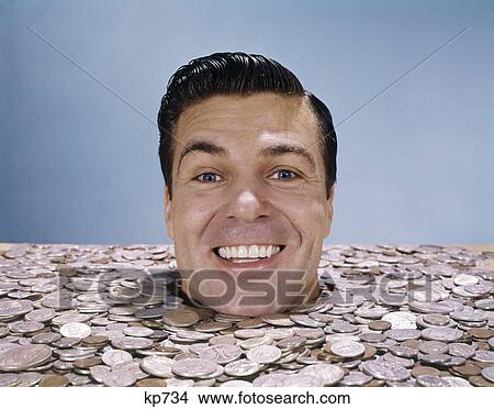 1960S Mans Face Head Buried Up To Neck In Coins Money Happy Wealth Luck Lucky Rich Smile Finance Retro Vintage View Large Photo Image Picture - 1960S Mans Face Head Buried Up To Neck In Coins Money Happy Wealth Luck Lucky Rich Smile Finance Retro Vintage. Fotosearch