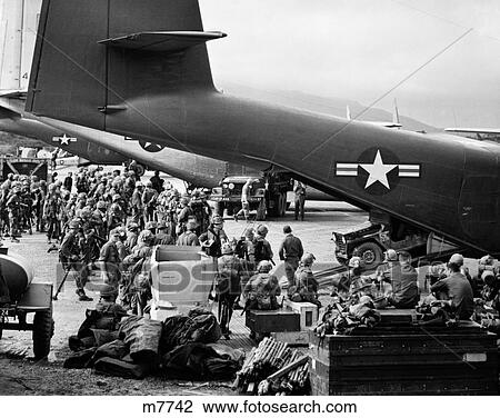 1960S Military Personnel Gathered Under Tails Of Planes In Airfield Waiting To Be Airlifted For Special Operation View Large Photo Image Stock Image - 1960S Military Personnel Gathered Under Tails Of Planes In Airfield Waiting To Be Airlifted For Special Operation . Fotosearch