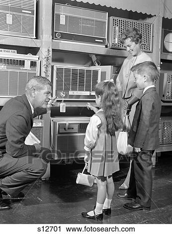 Stock Image - 1960S Mother Boy & Girl With Air Conditioning Salesman . Fotosearch