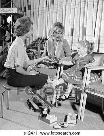 1960S Mother & Daughter Shopping Shoes Saleswoman Showing Patent Leather Shoe To Girl To Try On Retail Store View Large Photo Image Stock Image - 1960S Mother & Daughter Shopping Shoes Saleswoman Showing Patent Leather Shoe To Girl To Try On Retail Store . Fotosearch