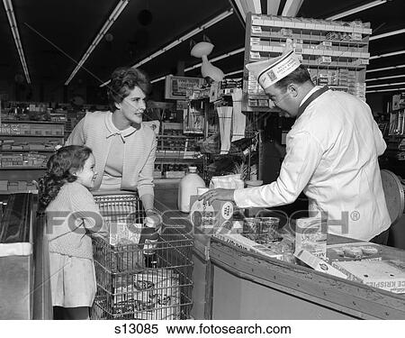 1960S Mother Daughter Unload Grocery Cart Checkout Counter Man Clerk Cashier Rings Up Groceries Food Store Supermarket View Large Photo Image Stock Photography - 1960S Mother Daughter Unload Grocery Cart Checkout Counter Man Clerk Cashier Rings Up Groceries Food Store Supermarket. Fotosearch