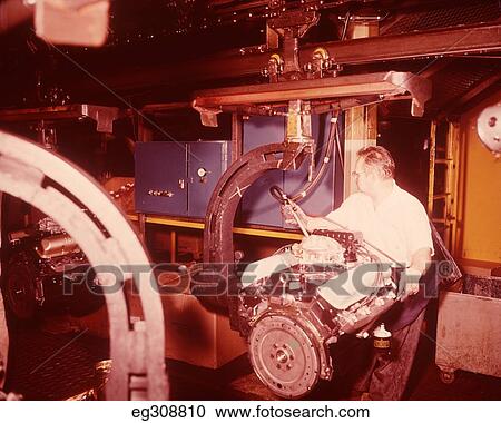 1960S Motor Factory Assembly Line Worker Adjusting Engine View Large Photo Image Stock Image - 1960S Motor Factory Assembly Line Worker Adjusting Engine. Fotosearch