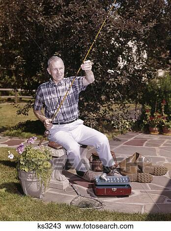 1960S Older Man Sitting In Backyard With Fishing Rod And Gear Tackle Box Boots Creel Net Retired Hobby View Large Photo Image Stock Image - 1960S Older Man Sitting In Backyard With Fishing Rod And Gear Tackle Box Boots Creel Net Retired Hobby. Fotosearch