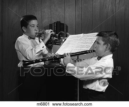 Stock Image - 1960S Pair Of Boys At Music Stand Wearing White Shirts & Bowties One Playing Trumpet & One Playing Clarinet . Fotosearch