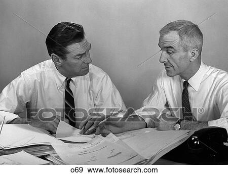 1960S Pair Of Men In Shirt & Tie With Sleeves Rolled Up Going Over Paperwork View Large Photo Image Stock Photo - 1960S Pair Of Men In Shirt & Tie With Sleeves Rolled Up Going Over Paperwork . Fotosearch