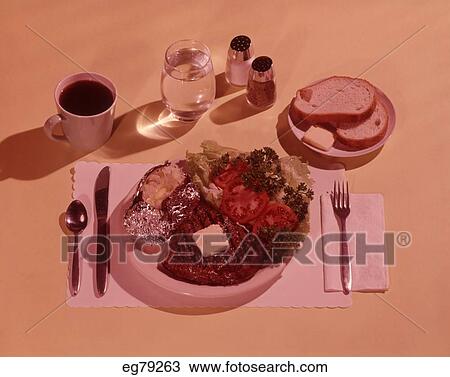 Stock Image - 1960S Place Setting Pate With Steak And Potato Entree. Fotosearch