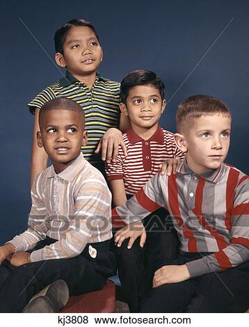 Stock Photo - 1960S Portrait 4 Boys In Striped Tee Shirts Ethnic & Racial Asian Hispanic African-American Caucasian. Fotosearch