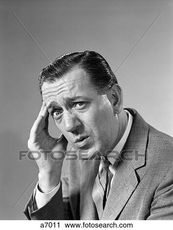 1960S Portrait Man In Suit & Tie With Wrinkled Brow Wincing & Holding Forehead View Large Photo Image Stock Image - 1960S Portrait Man In Suit & Tie With Wrinkled Brow Wincing & Holding Forehead . Fotosearch