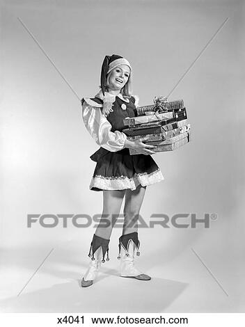 1960S Portrait Of Woman In Santa Costume Holding Xmas Packages View Large Photo Image Stock Image - 1960S Portrait Of Woman In Santa Costume Holding Xmas Packages . Fotosearch