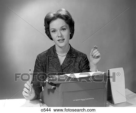 1960S Portrait Secretary Seated Behind Typewriter With Steno Book To Side & Pencil In Hand View Large Photo Image Picture - 1960S Portrait Secretary Seated Behind Typewriter With Steno Book To Side & Pencil In Hand . Fotosearch