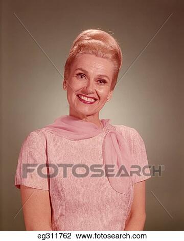 Stock Image - 1960S Portrait Smiling Blond Woman Pink Blouse Scarf. Fotosearch