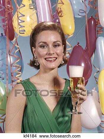 1960S Portrait Woman Green Dress Surrounded By Balloons Holding A Glass Of Beer Celebration View Large Photo Image Picture - 1960S Portrait Woman Green Dress Surrounded By Balloons Holding A Glass Of Beer Celebration. Fotosearch