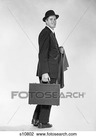 1960S Profile Full Figure Businessman Business Suit Tie Overcoat On Arm Holding Briefcase Smiling View Large Photo Image Stock Image - 1960S Profile Full Figure Businessman Business Suit Tie Overcoat On Arm Holding Briefcase Smiling. Fotosearch