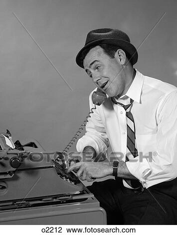 Stock Image - 1960S Reporter With Hat On Phone At Typewriter . Fotosearch