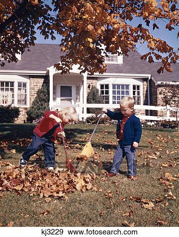 1960S Retro Little Boy Little Girl Sister And Brother Raking Autumn Leaves On Front Lawn Of Suburban House View Large Photo Image Stock Photo - 1960S Retro Little Boy Little Girl Sister And Brother Raking Autumn Leaves On Front Lawn Of Suburban House. Fotosearch