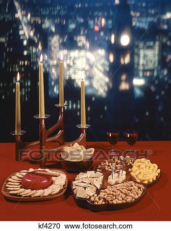 1960S Retro Tabletop Glasses Of Red Wine Finger Snack Food Cheese Crackers Mixed Nuts Peanuts Cheese Puffs Potato Chips View Large Photo Image Stock Image - 1960S Retro Tabletop Glasses Of Red Wine Finger Snack Food Cheese Crackers Mixed Nuts Peanuts Cheese Puffs Potato Chips. Fotosearch