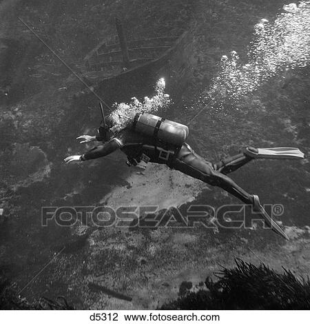 1960S Scuba Diver Underwater Swimming In Wet Suit And Flippers As Bubbles Rise From The Oxygen Tanks View Large Photo Image Stock Image - 1960S Scuba Diver Underwater Swimming In Wet Suit And Flippers As Bubbles Rise From The Oxygen Tanks . Fotosearch