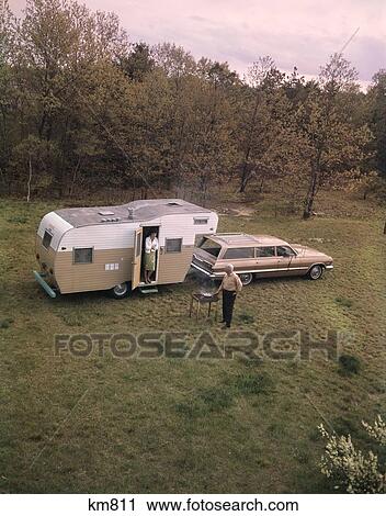 1960S Senior Man Grilling Woman Door Camper Hitched To Station Wagon View Large Photo Image Stock Image - 1960S Senior Man Grilling Woman Door Camper Hitched To Station Wagon . Fotosearch