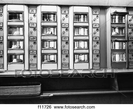 1960S Series Of Four Cafeteria Vending Machines Containing Cakes And Pies With Stack Of Trays On Counter Below View Large Photo Image Stock Photograph - 1960S Series Of Four Cafeteria Vending Machines Containing Cakes And Pies With Stack Of Trays On Counter Below . Fotosearch