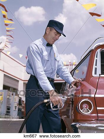 Stock Photo - 1960S Service Station Attendant With Pump Hose Filling Gas Tank Of Automobile. Fotosearch
