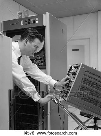 1960S Side View Of Man In Shirt & Tie Using Oscillascope To Check Electronic Components View Large Photo Image Stock Photo - 1960S Side View Of Man In Shirt & Tie Using Oscillascope To Check Electronic Components . Fotosearch